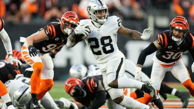 FILE - Las Vegas Raiders’ Josh Jacobs (28) runs during the first half of an NFL wild-card playoff football game against the Cincinnati Bengals, Saturday, Jan. 15, 2022, in Cincinnati. The Las Vegas Raiders are declining the fifth-year options on all three of their 2019 first-round picks as the new regime doesn’t want to commit to players inherited on the roster. General manager Dave Ziegler announced Friday, April 29, 2022, that the team will let defensive end Clelin Ferrell, running back Josh Jacobs and safety Johnathan Abram play out the final year of their rookie contracts instead of extending them through 2023. (AP Photo/AJ Mast, File)